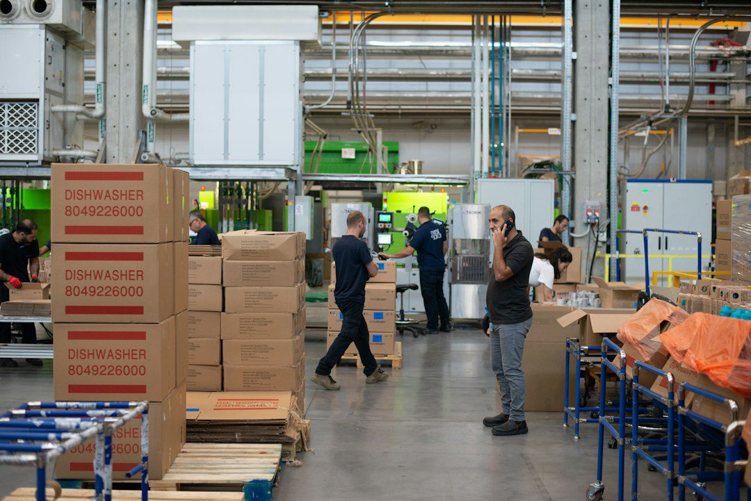 Factory production line workers demonstrating motion and transportation waste in manufacturing